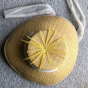 Yellow daisy woven sun hat with white scarf.
